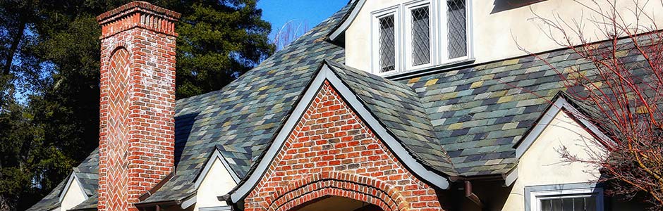 Varied Texture Roof Over a Brick Facade and Chimney